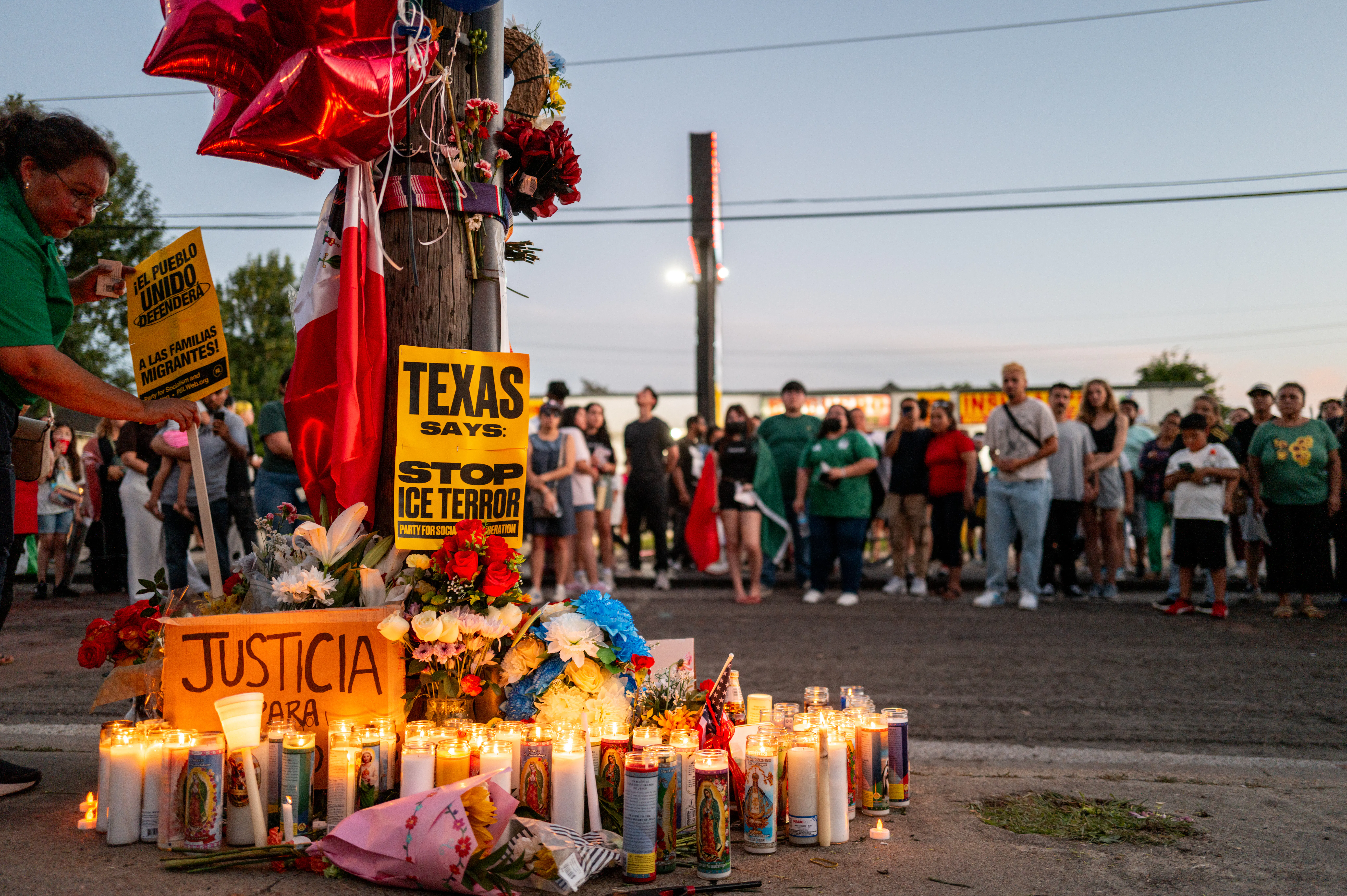 People pay their respects during a candlelight vigil at the site where Lorenzo Salgado Araujo was killed in Houston on July 8.