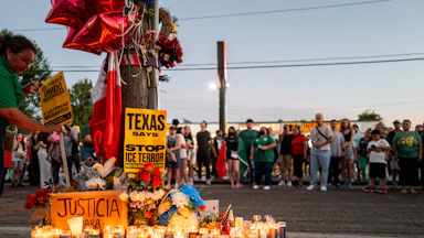People pay their respects during a candlelight vigil at the site where Lorenzo Salgado Araujo was killed in Houston on July 8.