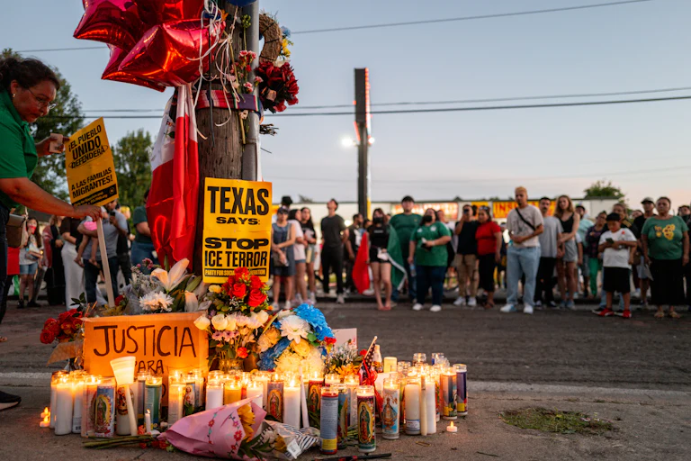 People pay their respects during a candlelight vigil at the site where Lorenzo Salgado Araujo was killed in Houston on July 8.