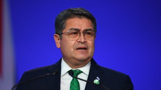 Former Honduran President Juan Orlando Hernández speaks into microphones