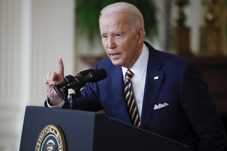 Joe Biden speaks at the presidential podium, and points a finger for emphasis