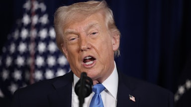 Donald Trump speaks into a microphone