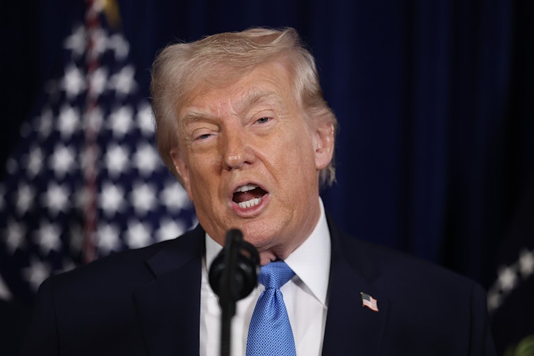 Donald Trump speaks into a microphone