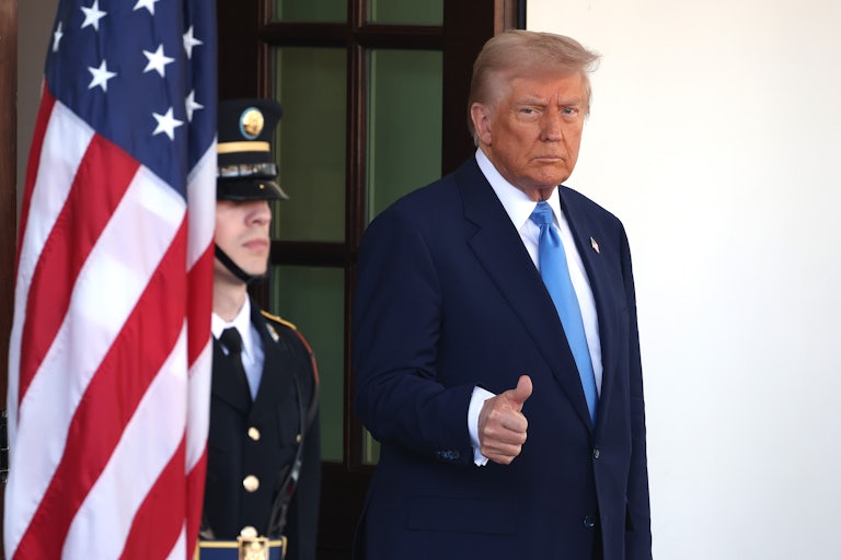 Donald Trump gives a thumbs up as he leaves the White House.