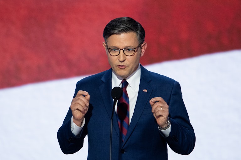 Mike Johnson gestures as he speaks onstage at the Republican National Convention