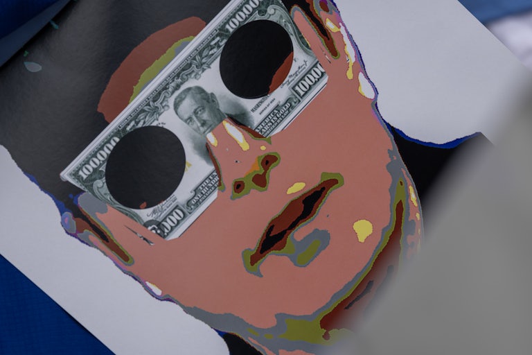 A protest sign with a digitized Elon Musk and a $100,000 bill over his eyes as sunglasses.