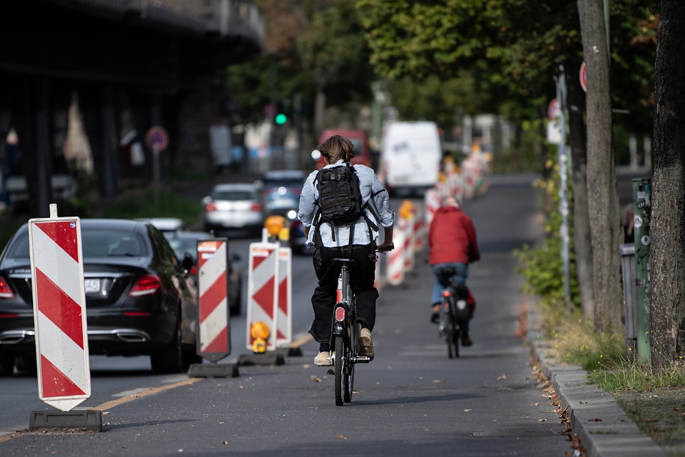 A person bikes in a bike lane.
