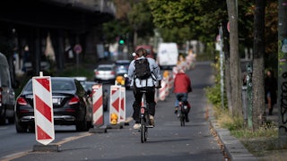 A person bikes in a bike lane.