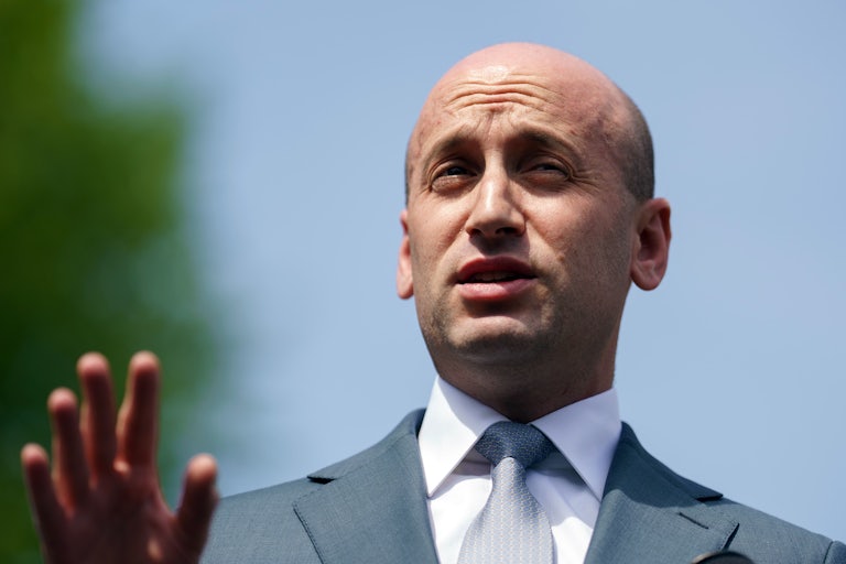 Stephen Miller gestures while speaking to reporters outside the White House