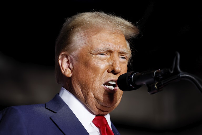 Donald Trump speaking into a mic