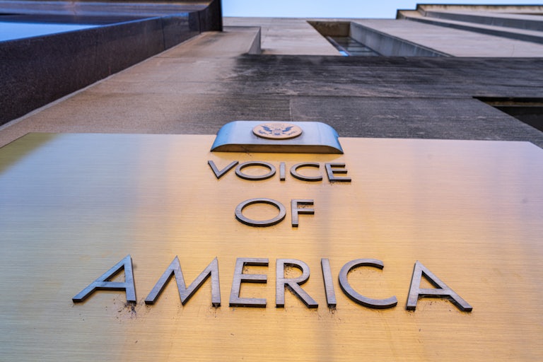 The Voice of America plaque on the side of the building