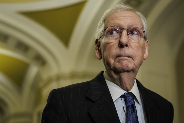 A leery Mitch Mcconnell looks away from the camera
