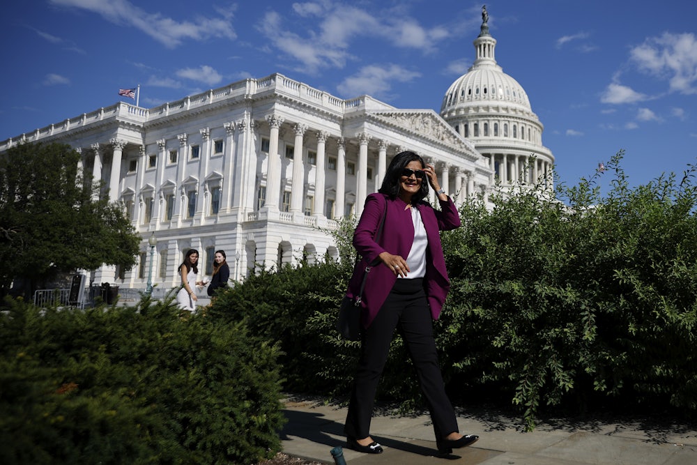 A smiling Rep. Pramila Jayapal arrives for a news conference with fellow members of the House Progressive Caucus ahead of the vote on the Inflation Reduction Act.