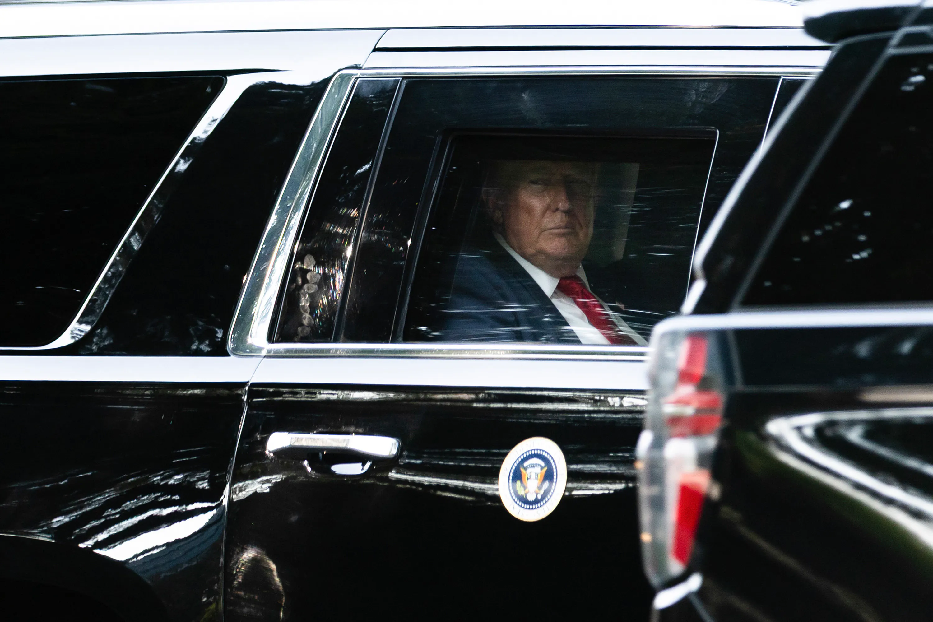 Donald Trump looks out the car window while riding in his motorcade.