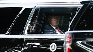Donald Trump looks out the car window while riding in his motorcade.