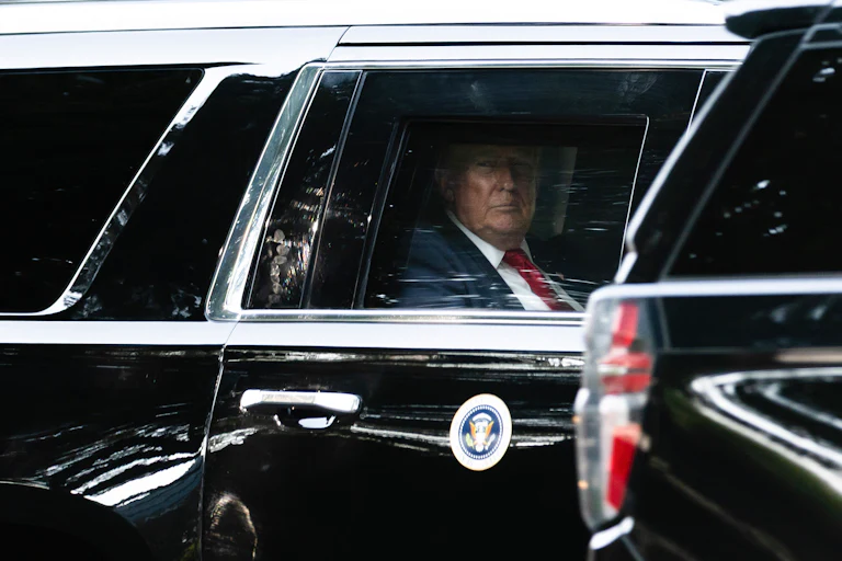 Donald Trump looks out the car window while riding in his motorcade.