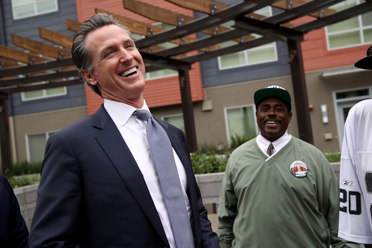 California Governor Gavin Newsom laughs with voters on the campaign trail.