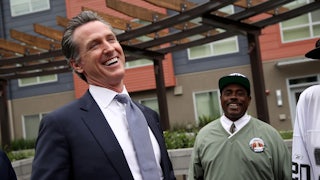 California Governor Gavin Newsom laughs with voters on the campaign trail.