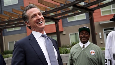 California Governor Gavin Newsom laughs with voters on the campaign trail.