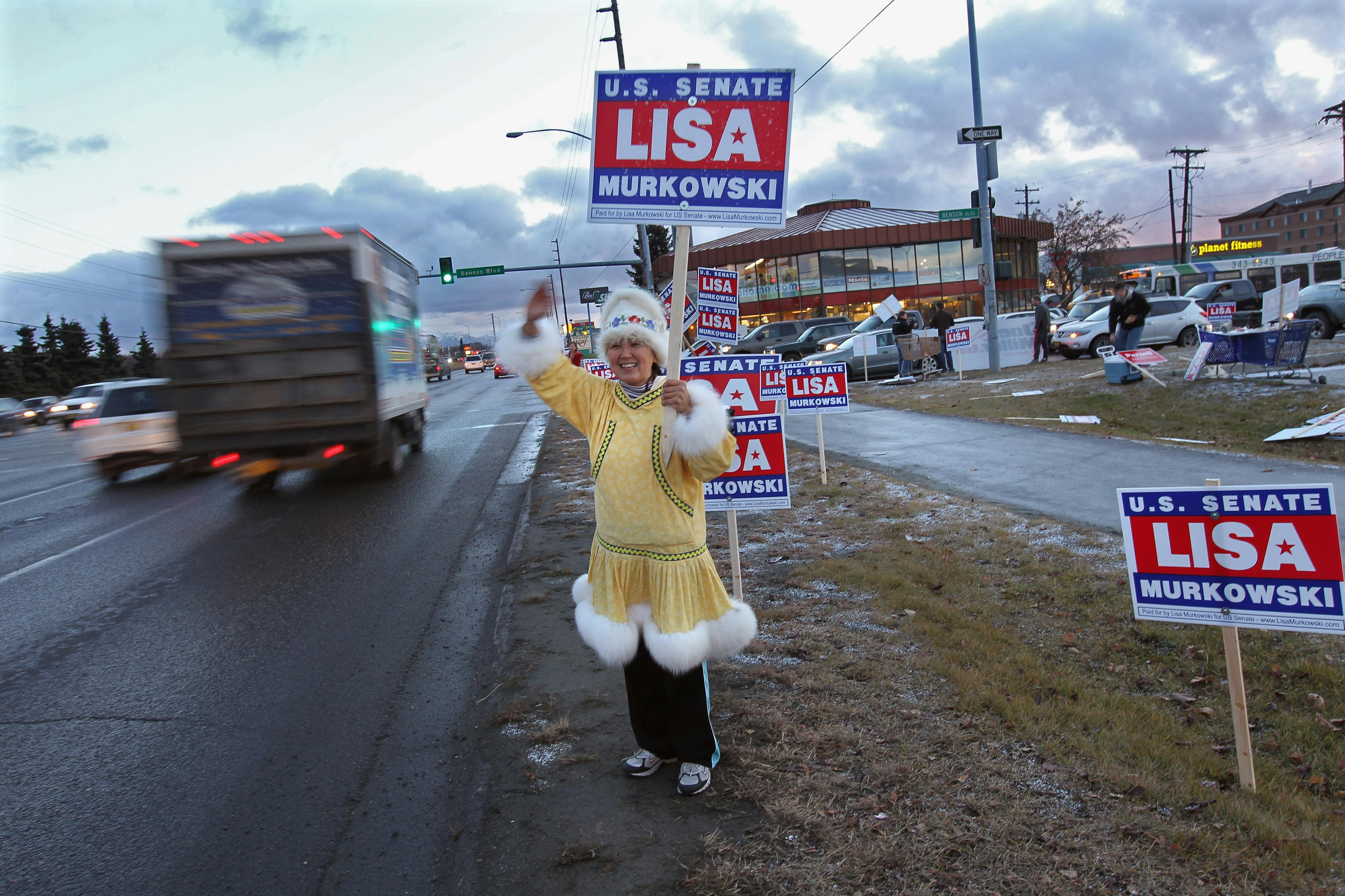 Darlene Heckler, an Inupiaq Native American, greets motorists while supporting U.S. Senator Lisa Murkowski for reelection in Anchorage, Alaska. 