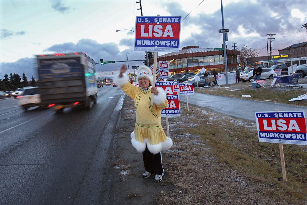 Darlene Heckler, an Inupiaq Native American, greets motorists while supporting U.S. Senator Lisa Murkowski for reelection in Anchorage, Alaska.