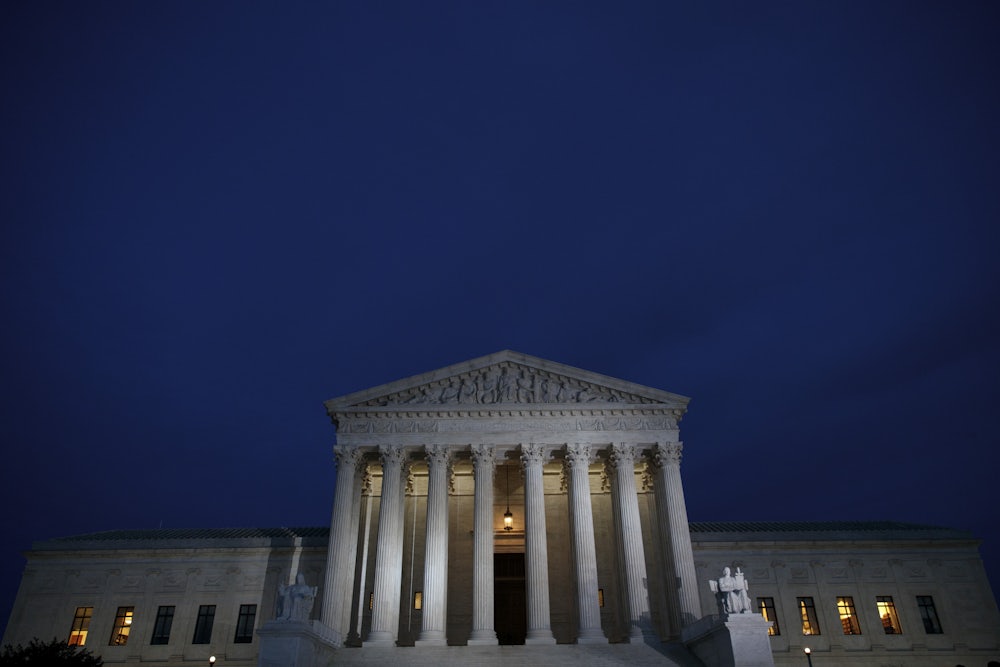 A view of the Supreme Court at dusk.