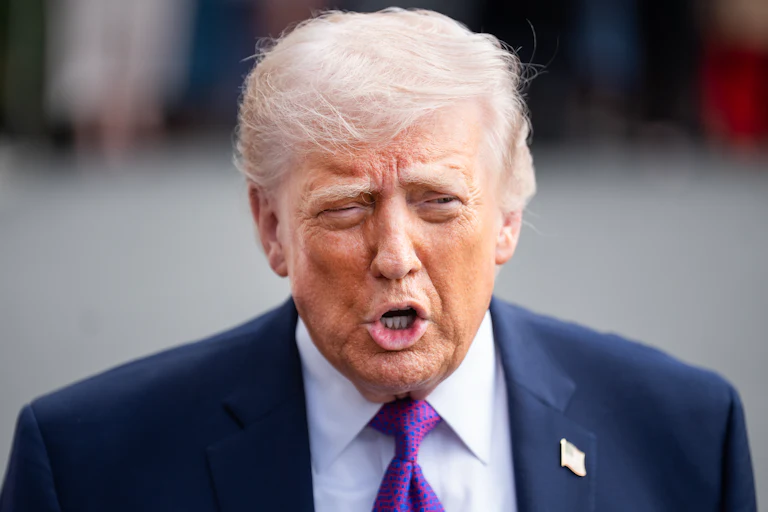 Donald Trump speaks to reporters outside the White House