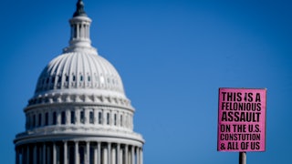A sign near the U.S. Capitol reads "This is a felonious assault on the U.S. Constitution & all of us."