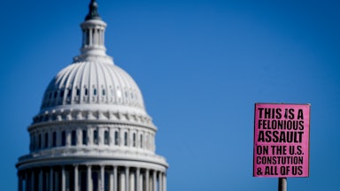 A sign near the U.S. Capitol reads "This is a felonious assault on the U.S. Constitution & all of us."