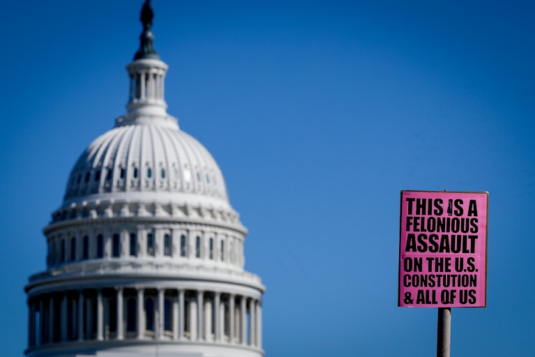 A sign near the U.S. Capitol reads "This is a felonious assault on the U.S. Constitution & all of us."