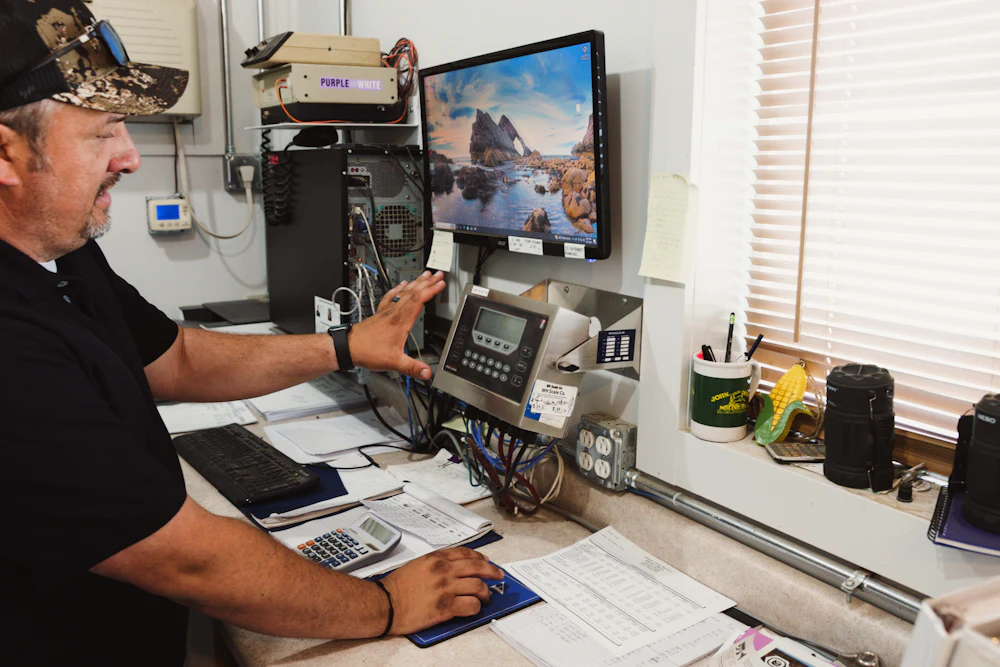 A photograph of Brett Neibling running his Highland, Kansas, farm from his office.