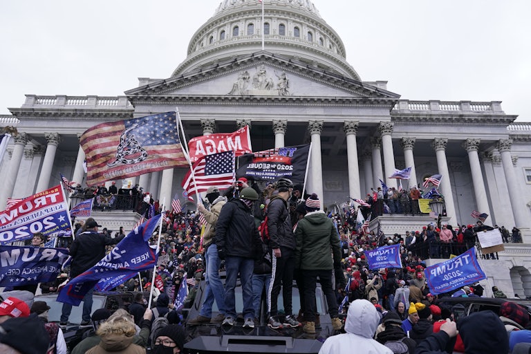 Rioters wavingn pro-Trump and U.S. flags at the Capitol on January 6, 2021