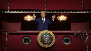 Donald Trump holds his hands up while standing in the Presidential Box of the Opera House at the Kennedy Center