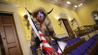 Jacob Anthony Chansley screams "Freedom" inside the Senate chamber after the U.S. Capitol was breached by a mob during a joint session of Congress on January 06, 2021 in Washington, DC.