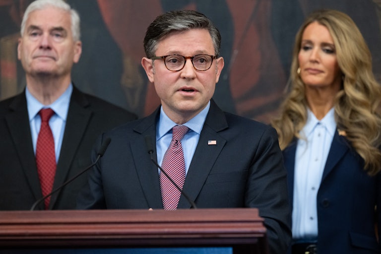House Speaker Mike Johnson speaks in the Capitol. House Majority Whip Tom Emmer and SBA Administrator Kelly Loeffler are in the background.