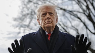 Donald Trump puts both hands up