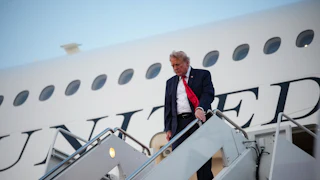 Donald Trump looks down while disembarking from Air Force One.