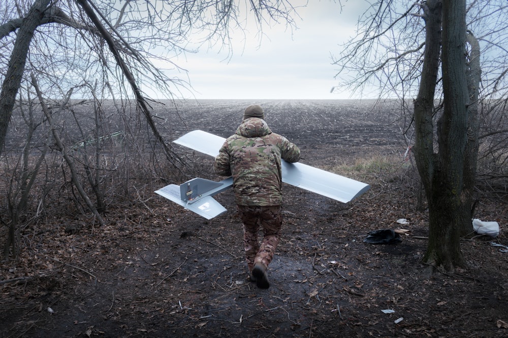 Volodymyr heads toward the field where he will launch the Darts drone.