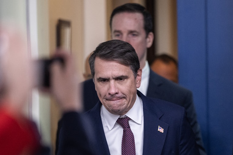 Deputy Attorney General Todd Blanche bites his lip while walking in the White House