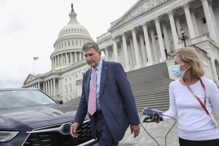 West Virginia Senator Joe Manchin walks down the steps of the U.S. Capitol