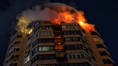 The upper floors of a building in Kyiv, Ukraine, burn after a Russian attack