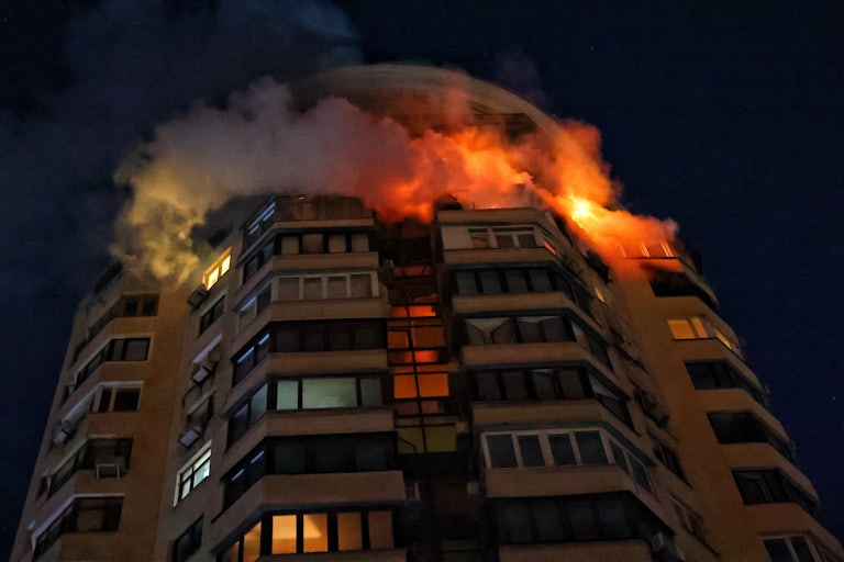 The upper floors of a building in Kyiv, Ukraine, burn after a Russian attack