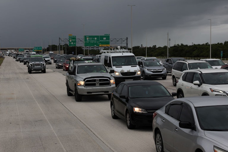 A picture of a highway shows nearly bumper-to-bumper traffic.
