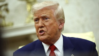 Donald Trump speaks angrily while seated in the Oval Office of the White House.