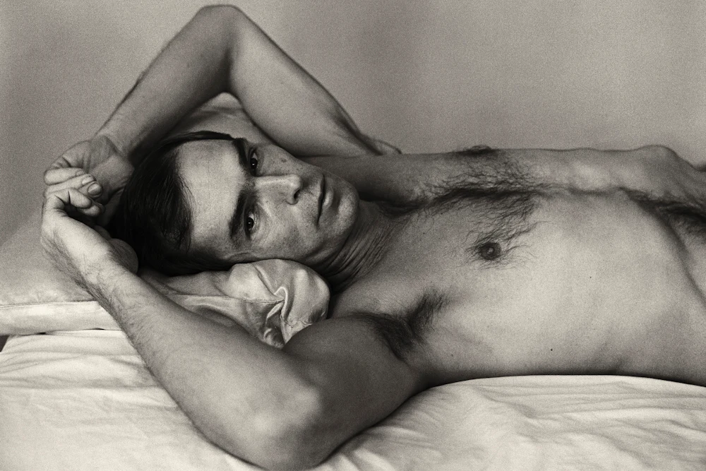 A black and white photograph titled Self‑Portrait Lying Down by Peter Hujar