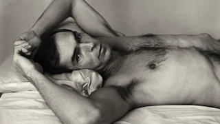 A black and white photograph titled Self‑Portrait Lying Down by Peter Hujar