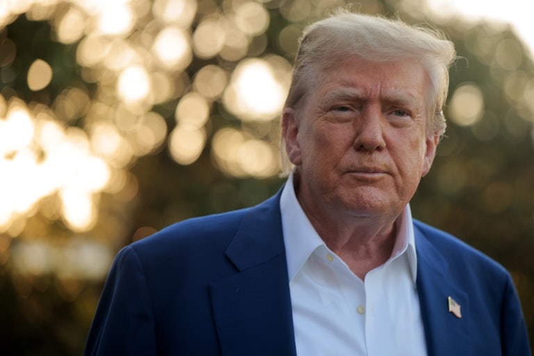 Donald Trump walks outside the White House