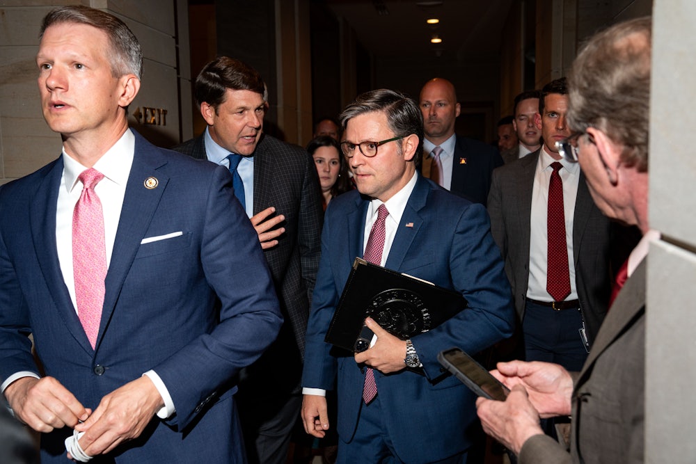 House Speaker Mike Johnson, center, spoke with Representative Jodey Arrington, center left, at the U.S. Capitol on May 15.