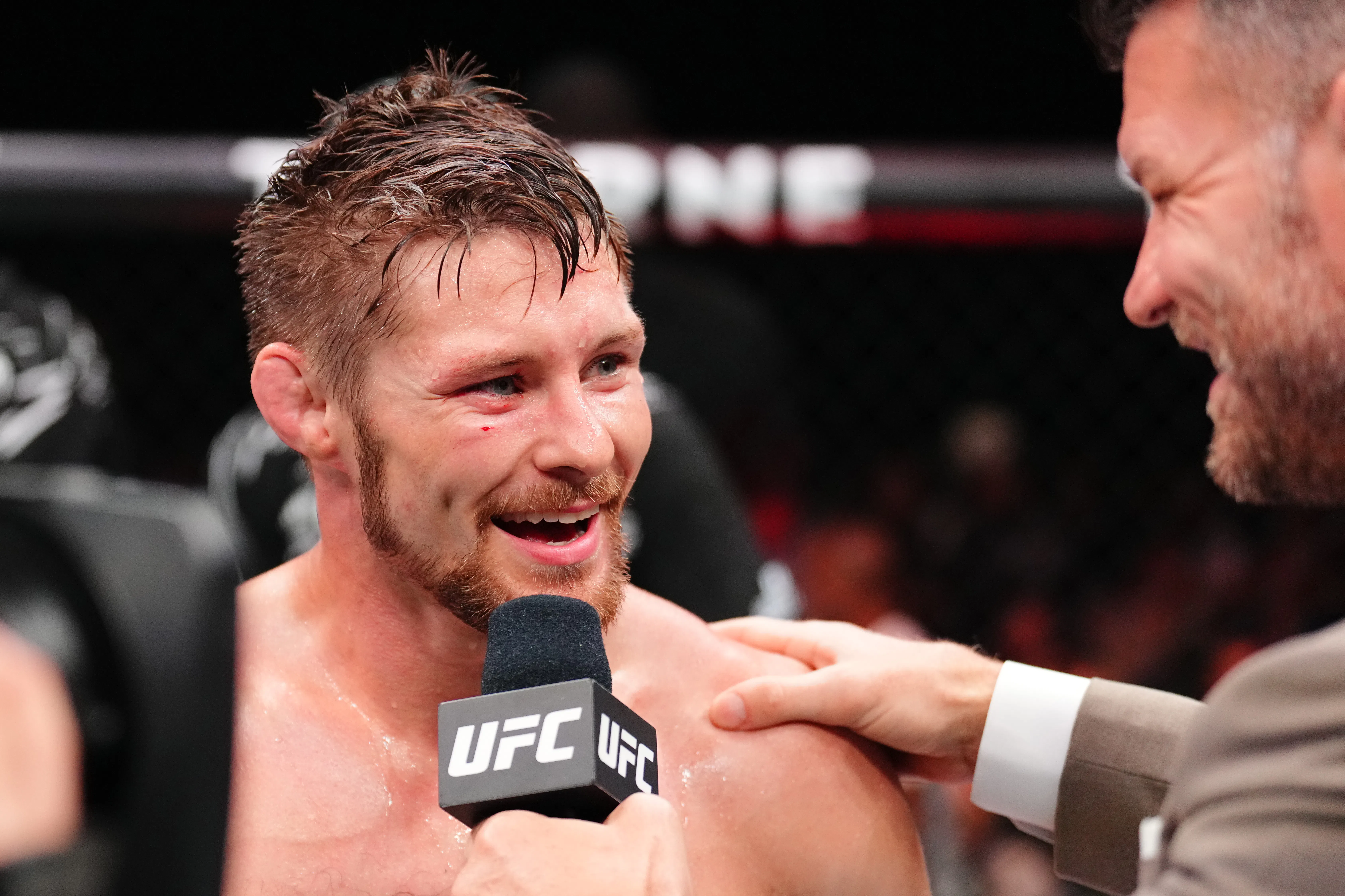 UFC fighter Bryce Mitchell smiles and speaks to a reporter after a match