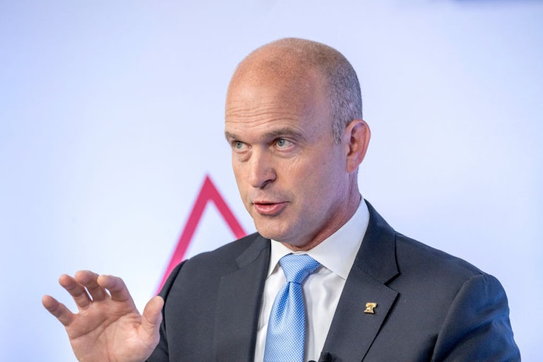 Kevin Roberts raises a hand while speaking